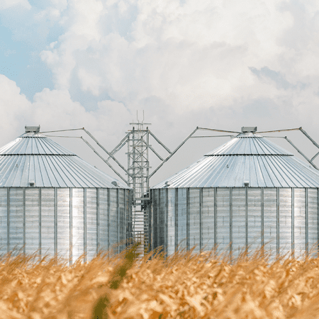 BP_K3_Agriculture_Featured Steel agricultural structures set against cloudy sky