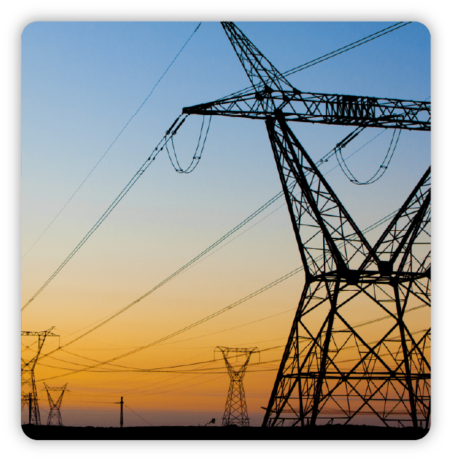 Electrical towers set against blue and gold sky