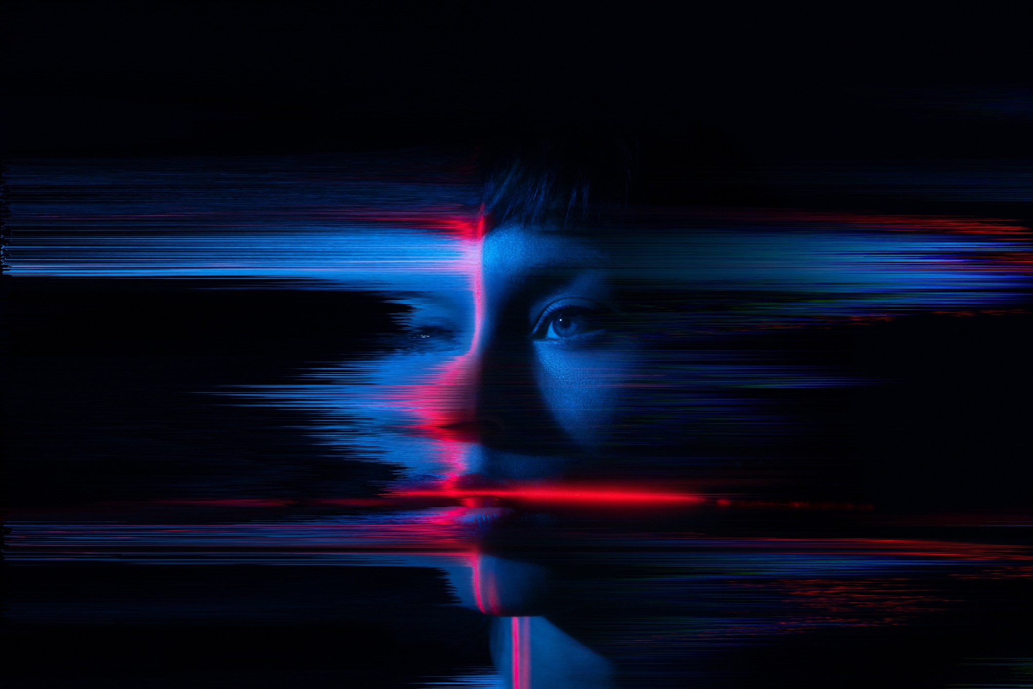 A young woman appears to glitch and fragment, symbolizing the merging of humanity with the digital world. A visual representation of contemporary themes such as AI, the metaverse and cyber culture