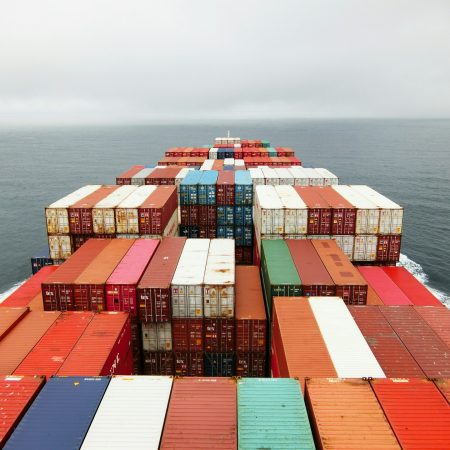 View of cargo containers and ocean from bridge