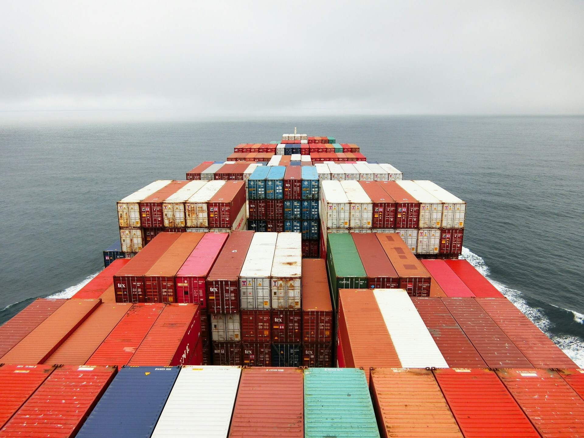 View of cargo containers and ocean from bridge