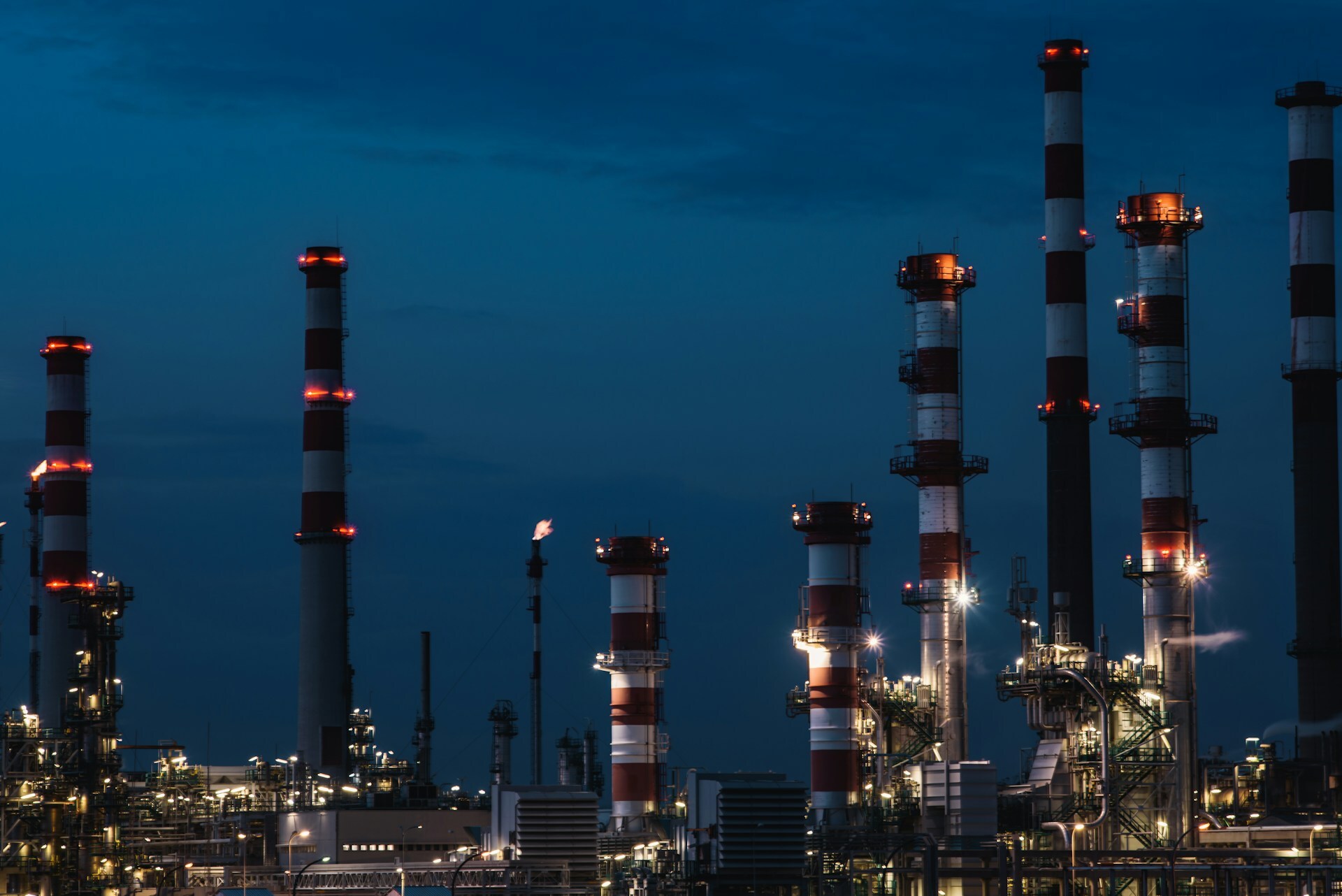 Towers from oil refinery at night