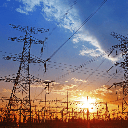 Rows of electrical towers against the sky at sunrise