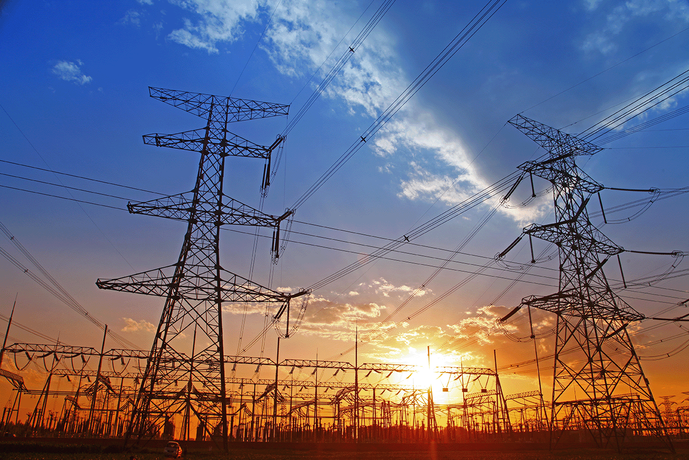 Rows of electrical towers against the sky at sunrise
