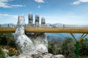 bridge being held by large hand