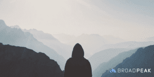 View of foggy mountain landscape with silhouette of hiker
