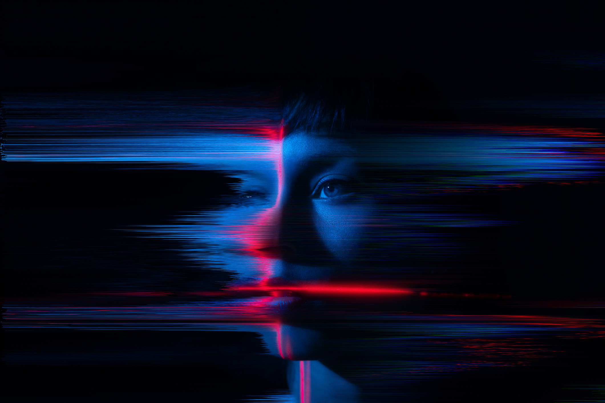 A young woman appears to glitch and fragment, symbolizing the merging of humanity with the digital world. A visual representation of contemporary themes such as AI, the metaverse and cyber culture
